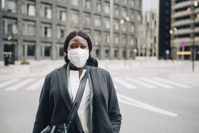 Portrait of female entrepreneur on street in city during covid-19