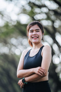 Portrait of young woman exercising in park