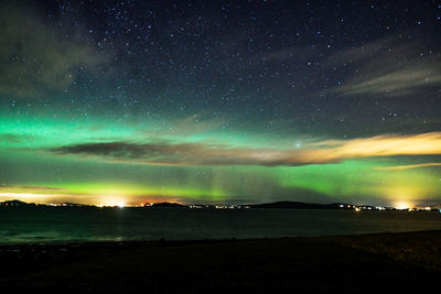 Scenic view of landscape against sky at night