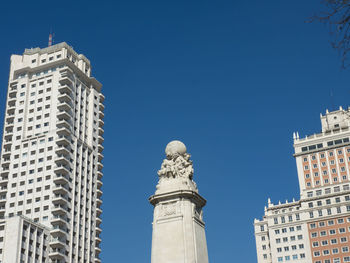Low angle view of buildings against blue sky