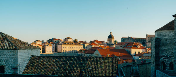 Buildings in city against clear sky