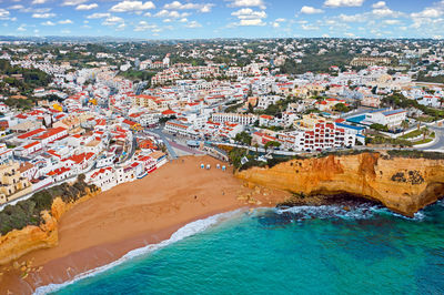 High angle view of townscape by sea against sky