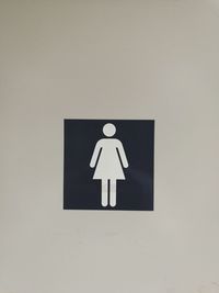 Close-up of arrow sign on wall