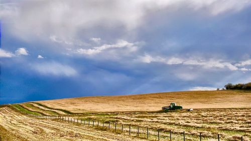 Scenic view of agricultural field against sky