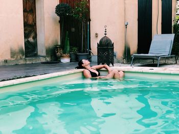 Low section of woman swimming in pool