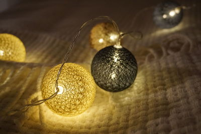 Close-up of illuminated decoration lights on bed