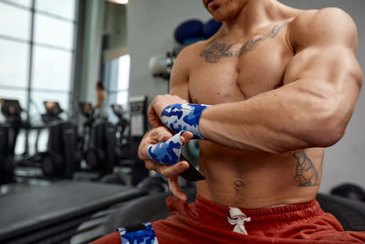 Man wearing wrist strap in gym