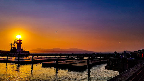 Silhouette of harbor during sunset
