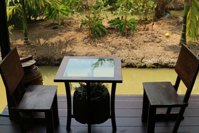 High angle view of empty chairs and table in yard