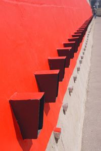 Rows of metals on red wall