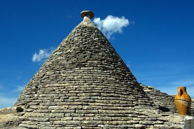 Low angle view of trullo houses at alberobello against sky