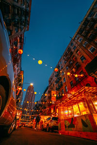 Illuminated buildings against sky at night