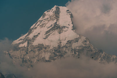 Scenic view of snowcapped mountains against sky during sunset