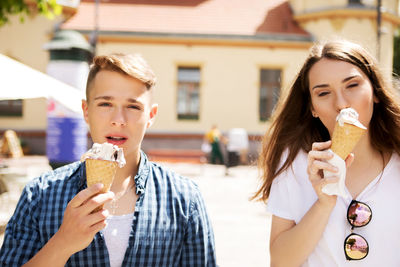 Friends eating ice cream in city
