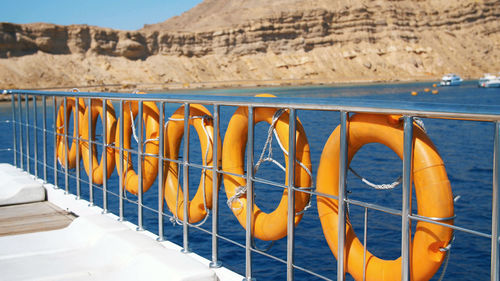 Summer, sea, orange lifebuoy, hanging aboard a ferry, ship. special rescue equipment of the ship