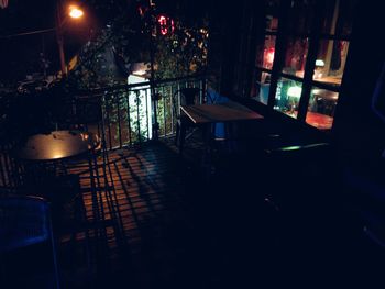 Empty chairs and table in illuminated room