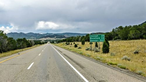 Road by landscape against sky