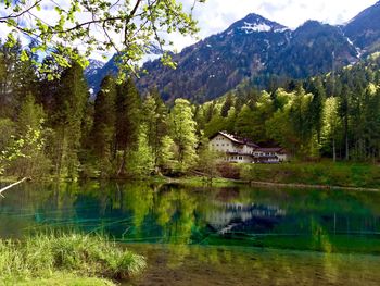 Scenic view of lake by trees against mountains