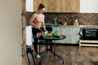 Sports woman cooking healthy eat at home