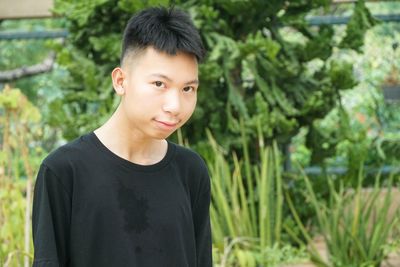 Portrait of young man standing outdoors