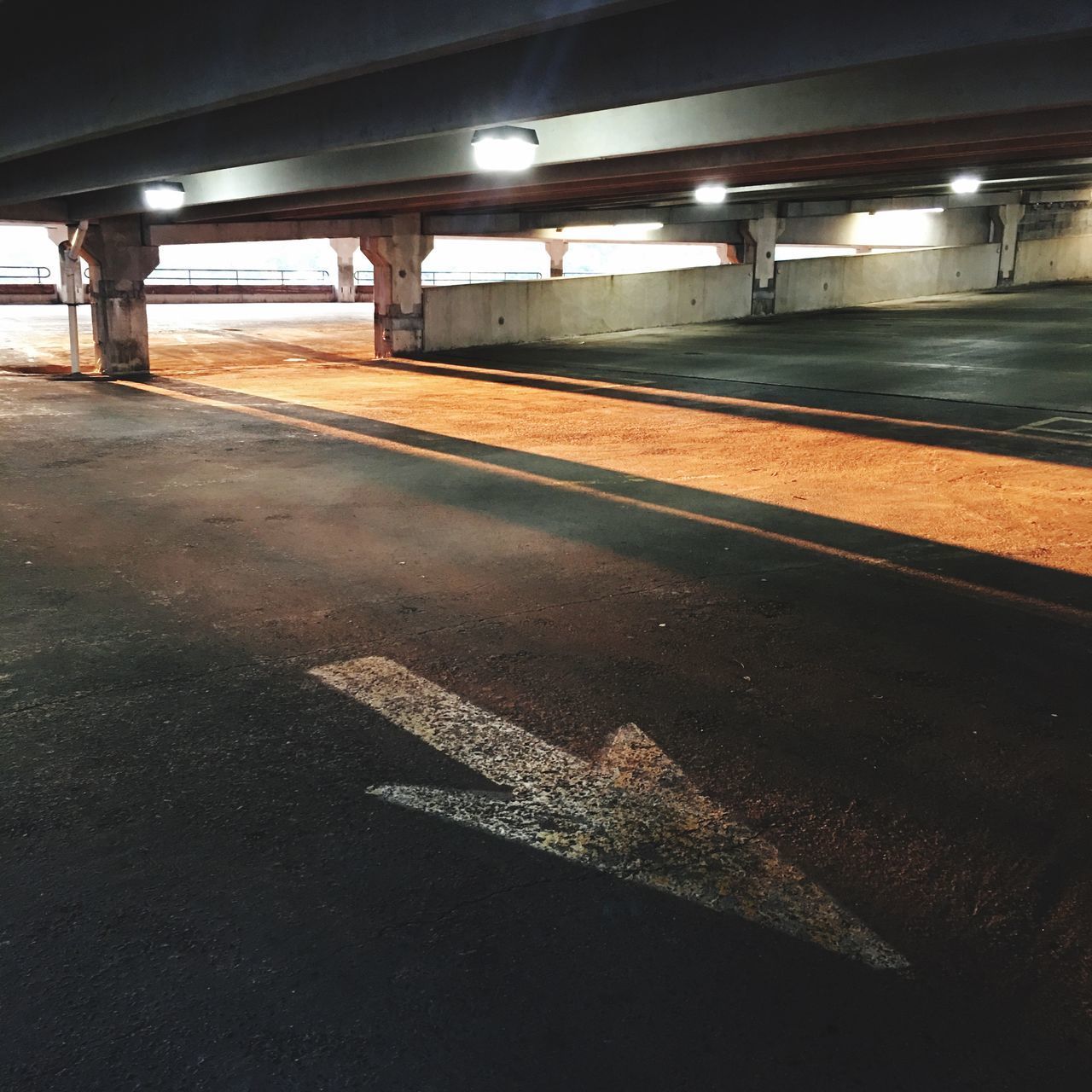 LIGHT TRAILS ON ROAD IN ILLUMINATED TUNNEL