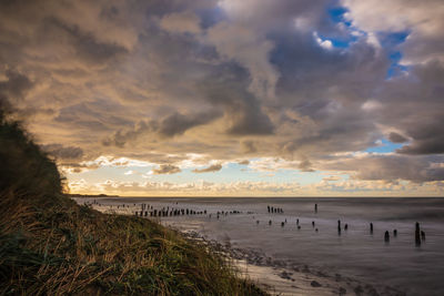 Scenic view of beach against sky during sunset