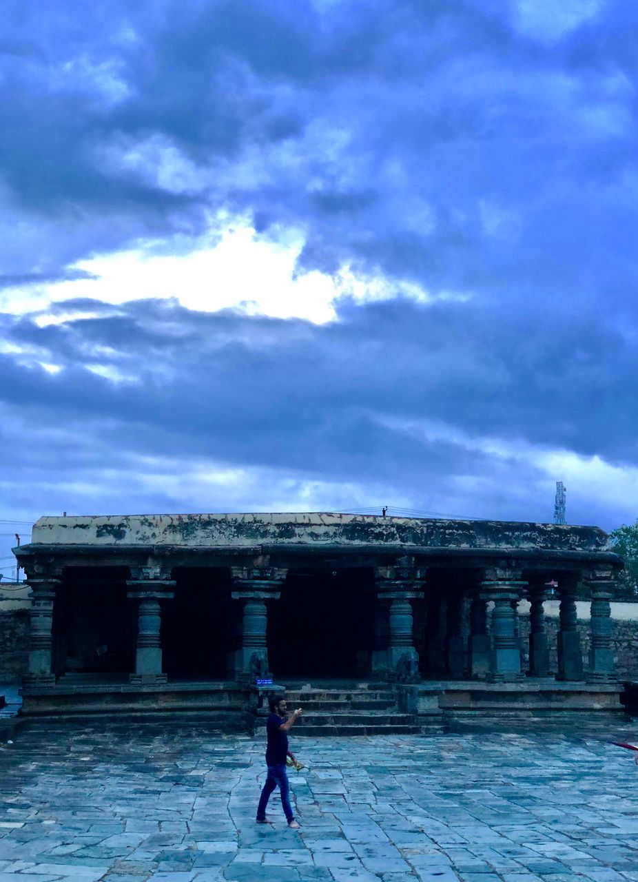 cloud - sky, sky, architecture, built structure, full length, lifestyles, people, real people, women, nature, leisure activity, men, building exterior, adult, walking, outdoors, history, the past