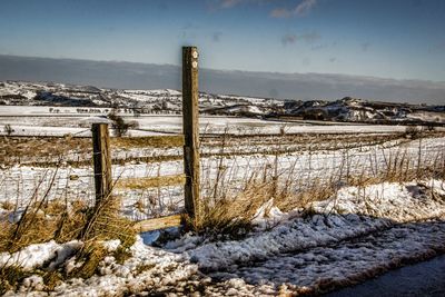 Snow covered landscape against sky