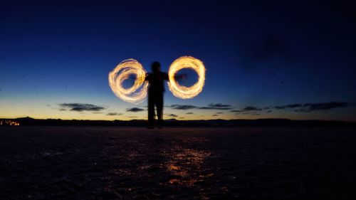 Light painting on field against sky at night