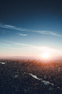 Aerial view of cityscape against sky during sunset