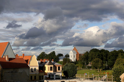 View of village against cloudy sky