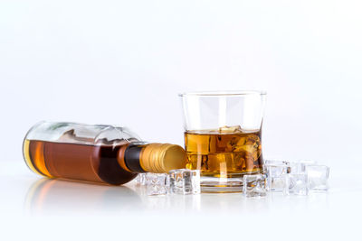 Close-up of beer bottles against white background