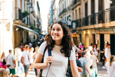 Portrait of smiling young woman standing outdoors