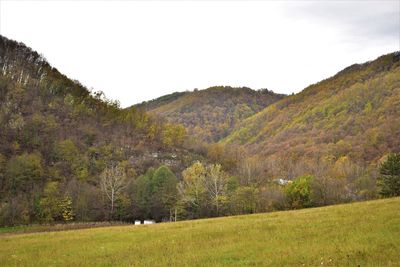 Scenic view of landscape and mountains against clear sky