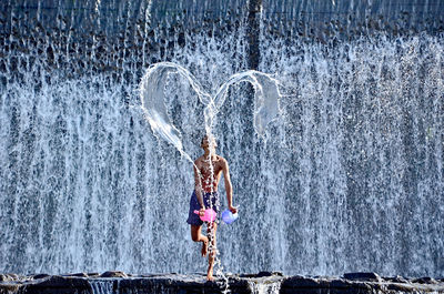 Teenage boy playing with water