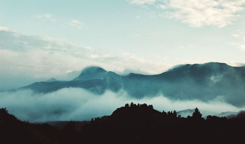 Scenic view of silhouette mountains against sky