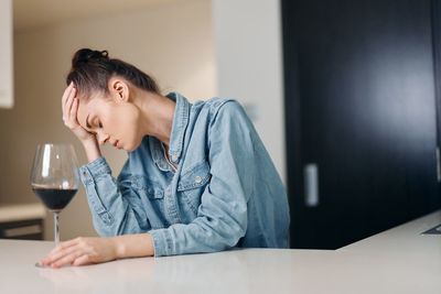 Young woman using mobile phone at home