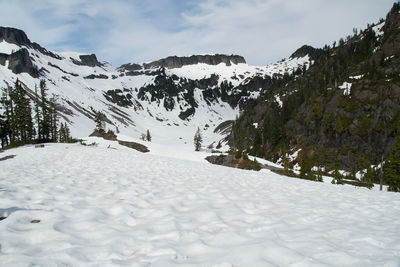 Scenic view of snow covered mountains against sky