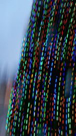 Low angle view of illuminated lights against sky