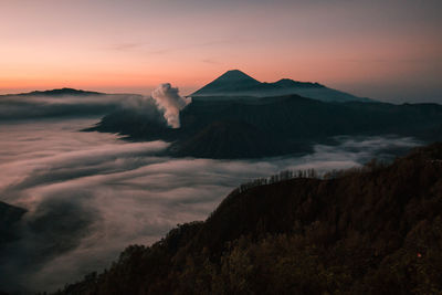 Scenic view of volcanic landscape against sky during sunset