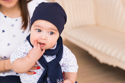 Close-up of cute baby girl at home