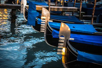 Close-up of gondola moored on canal