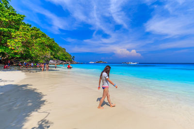 Full length of woman on beach against sky