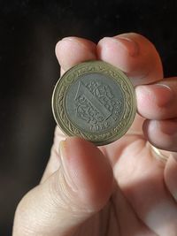 Close-up of hand holding coins