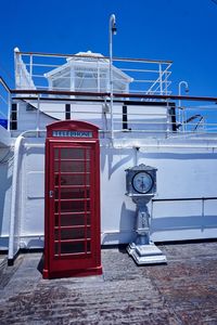 Telephone booth against blue sky