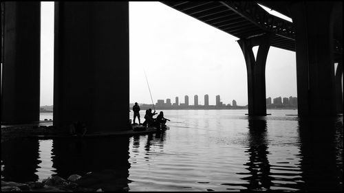 Silhouette of people on bridge