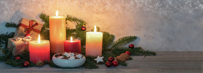 Close-up of illuminated candles on table