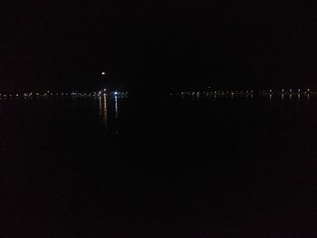 Illuminated city against sky at night