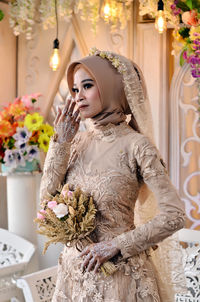 Portrait of bride holding bouquet