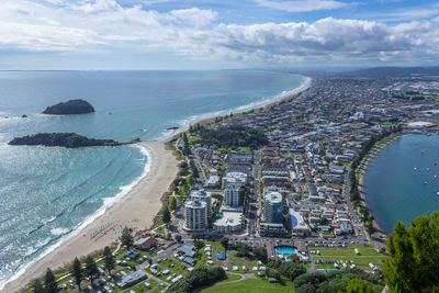 High angle view of buildings by sea against sky